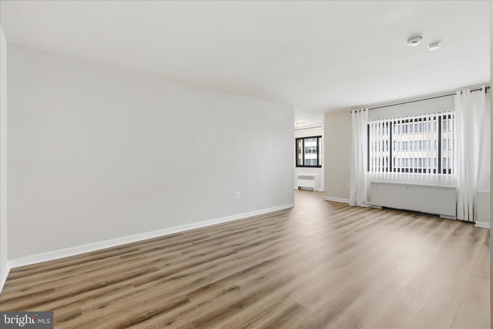 1200 South Arlington Ridge Road, Unit 717 Arlington, VA 22202 - Photo 4 of 24 a view of empty room with wooden floor and fan