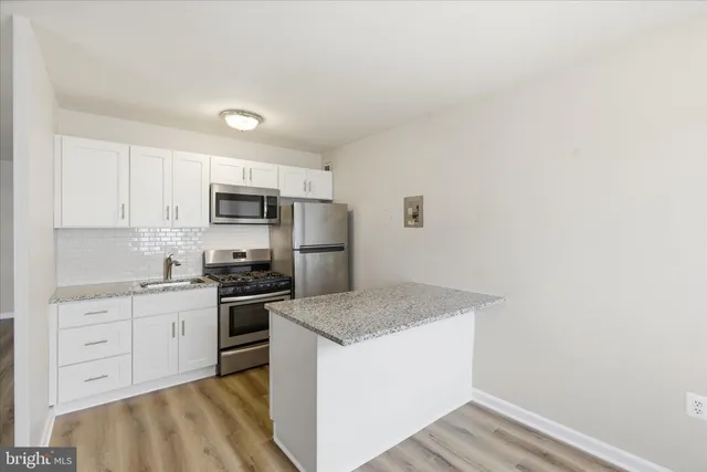 a kitchen with a sink a stove and refrigerator