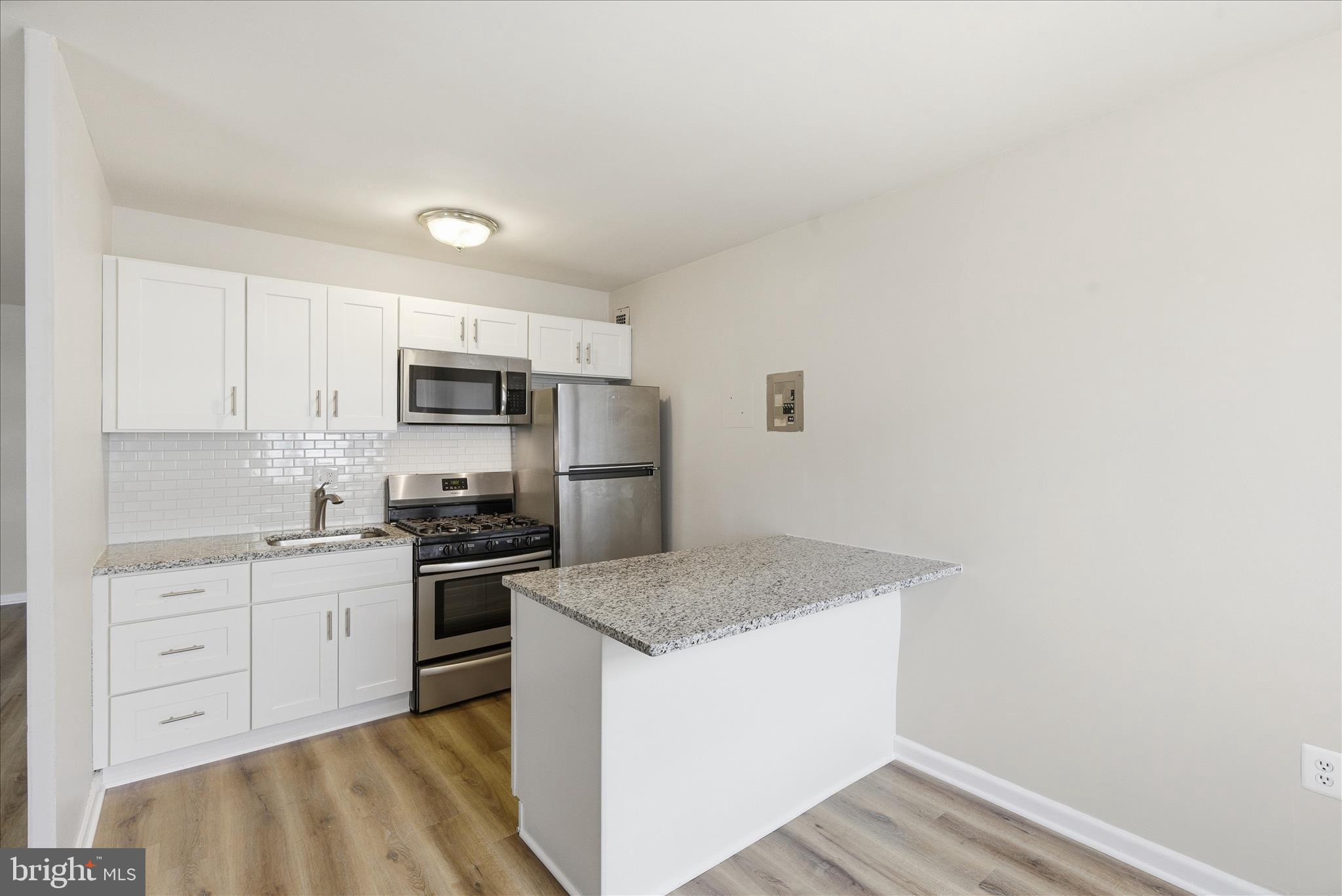 1200 South Arlington Ridge Road, Unit 717 Arlington, VA 22202 - Photo 8 of 24 a kitchen with a sink a stove and refrigerator