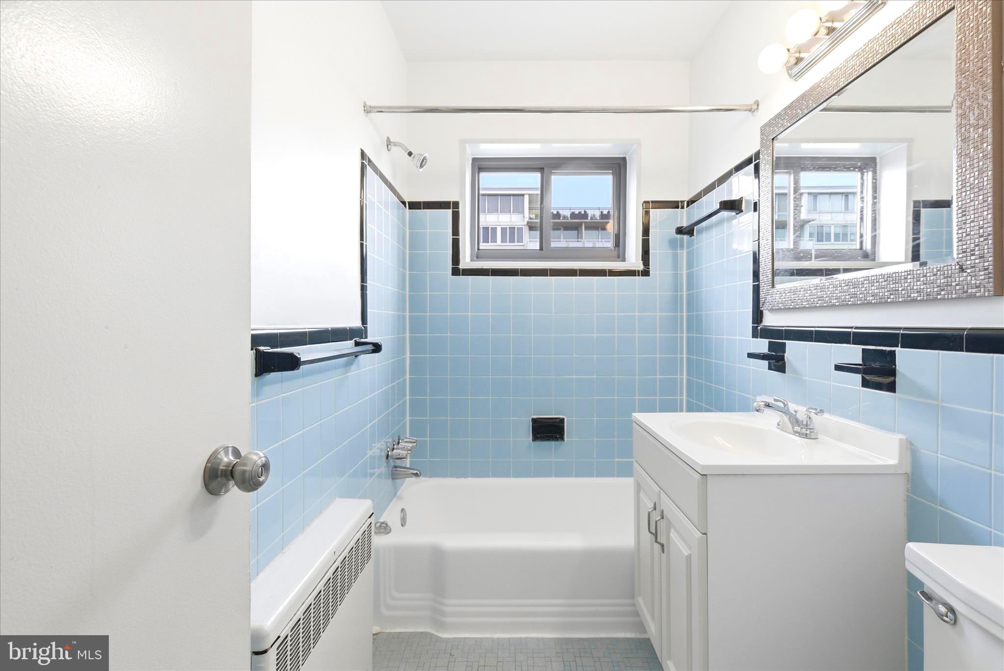 1200 South Arlington Ridge Road, Unit 717 Arlington, VA 22202 - Photo 10 of 24 a bathroom with a sink a toilet and shower