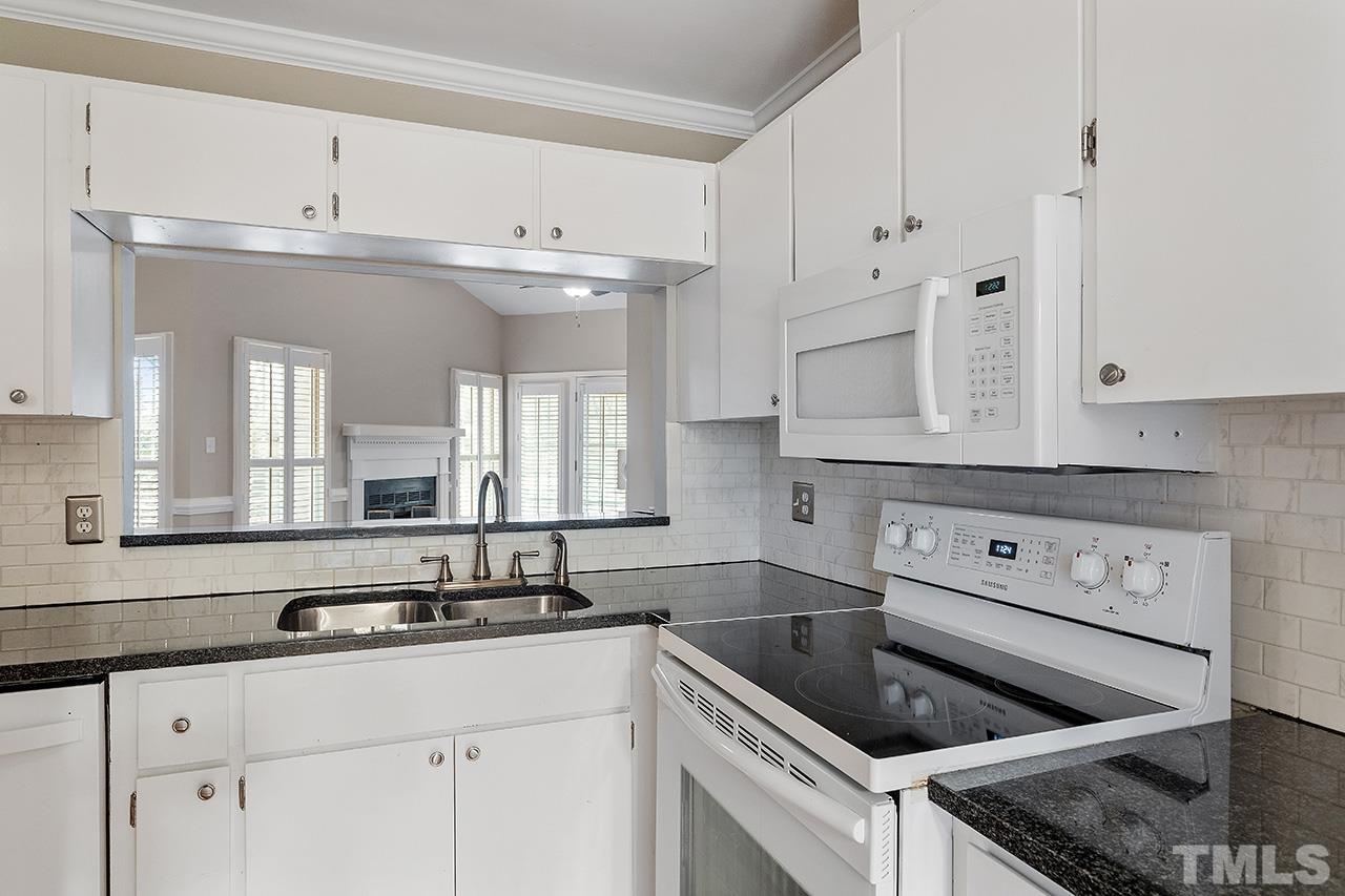 5701 Grasmere Court Raleigh, NC 27609 - Photo 11 of 34 a kitchen with cabinets appliances and a sink