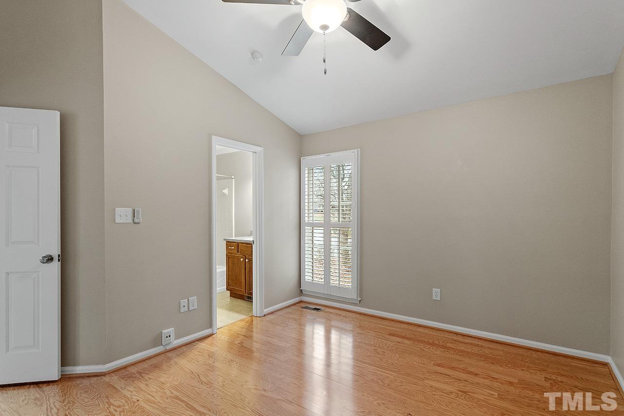 5701 Grasmere Court Raleigh, NC 27609 - Photo 17 of 34 an empty room with chandelier fan and windows