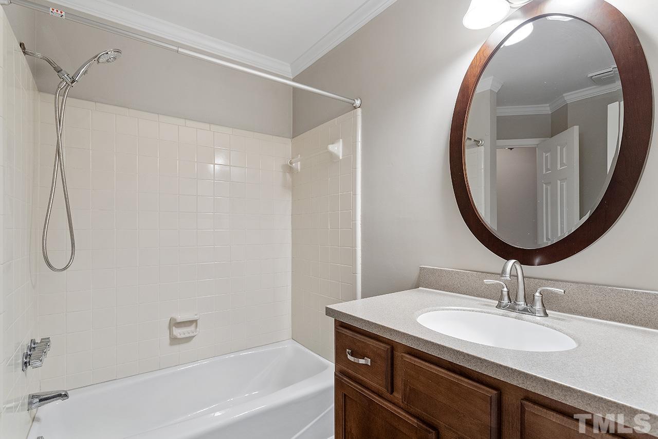 5701 Grasmere Court Raleigh, NC 27609 - Photo 18 of 34 a bathroom with a sink and a mirror