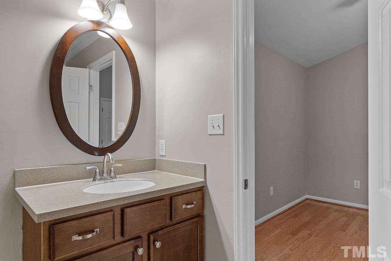 5701 Grasmere Court Raleigh, NC 27609 - Photo 19 of 34 a bathroom with a sink and a mirror