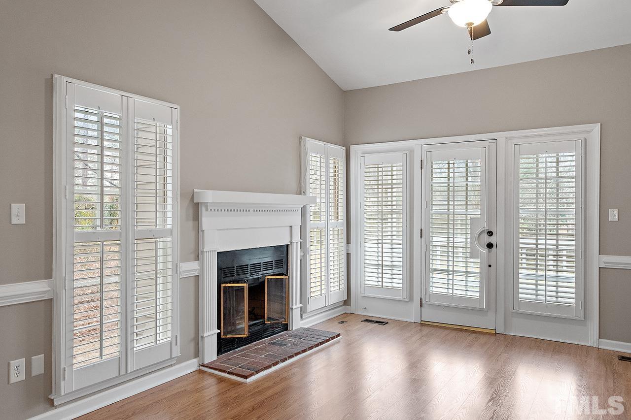 5701 Grasmere Court Raleigh, NC 27609 - Photo 24 of 34 a view of an empty room with wooden floor fireplace and a window