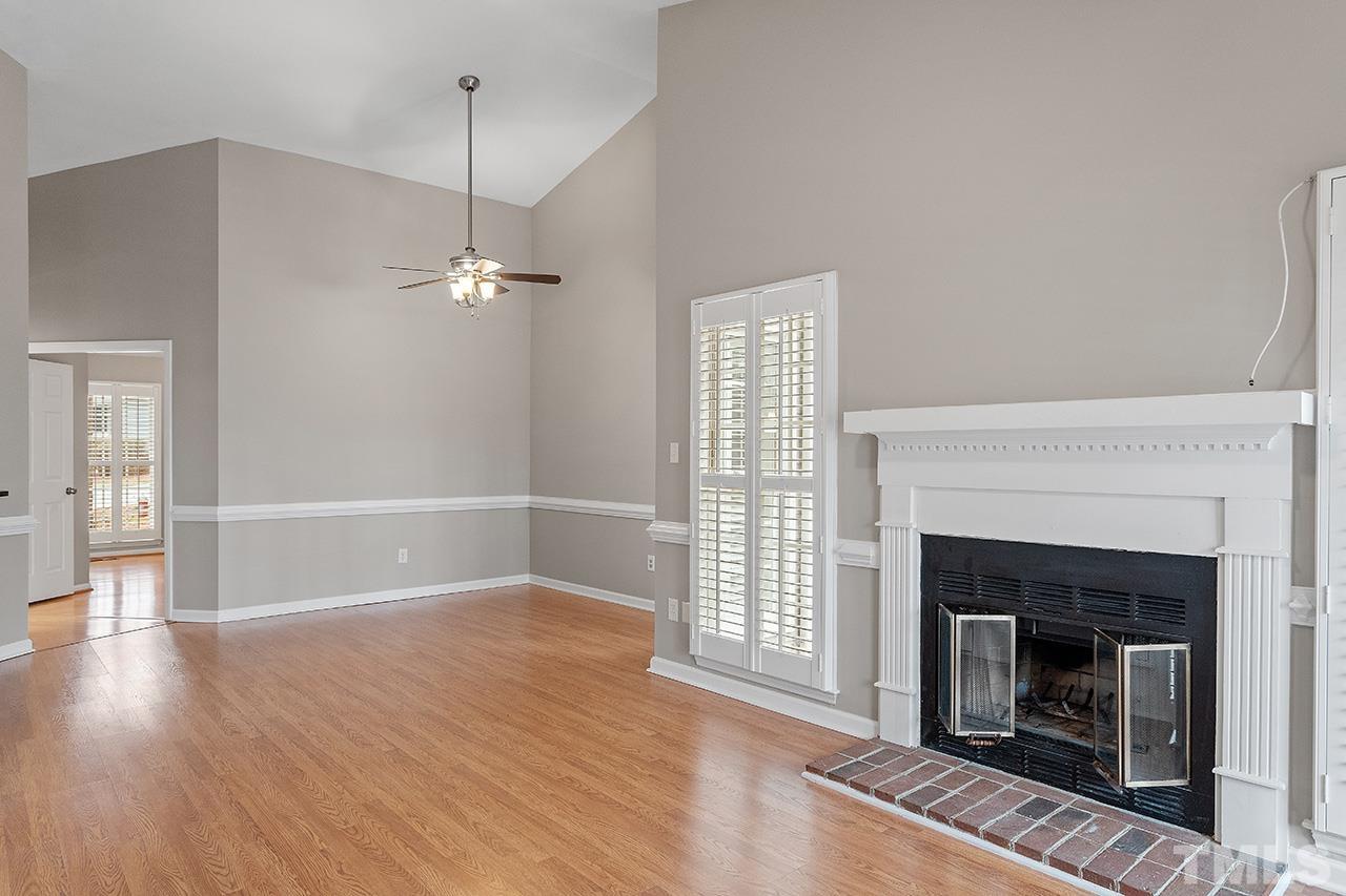 5701 Grasmere Court Raleigh, NC 27609 - Photo 28 of 34 a view of a livingroom with wooden floor and a fireplace