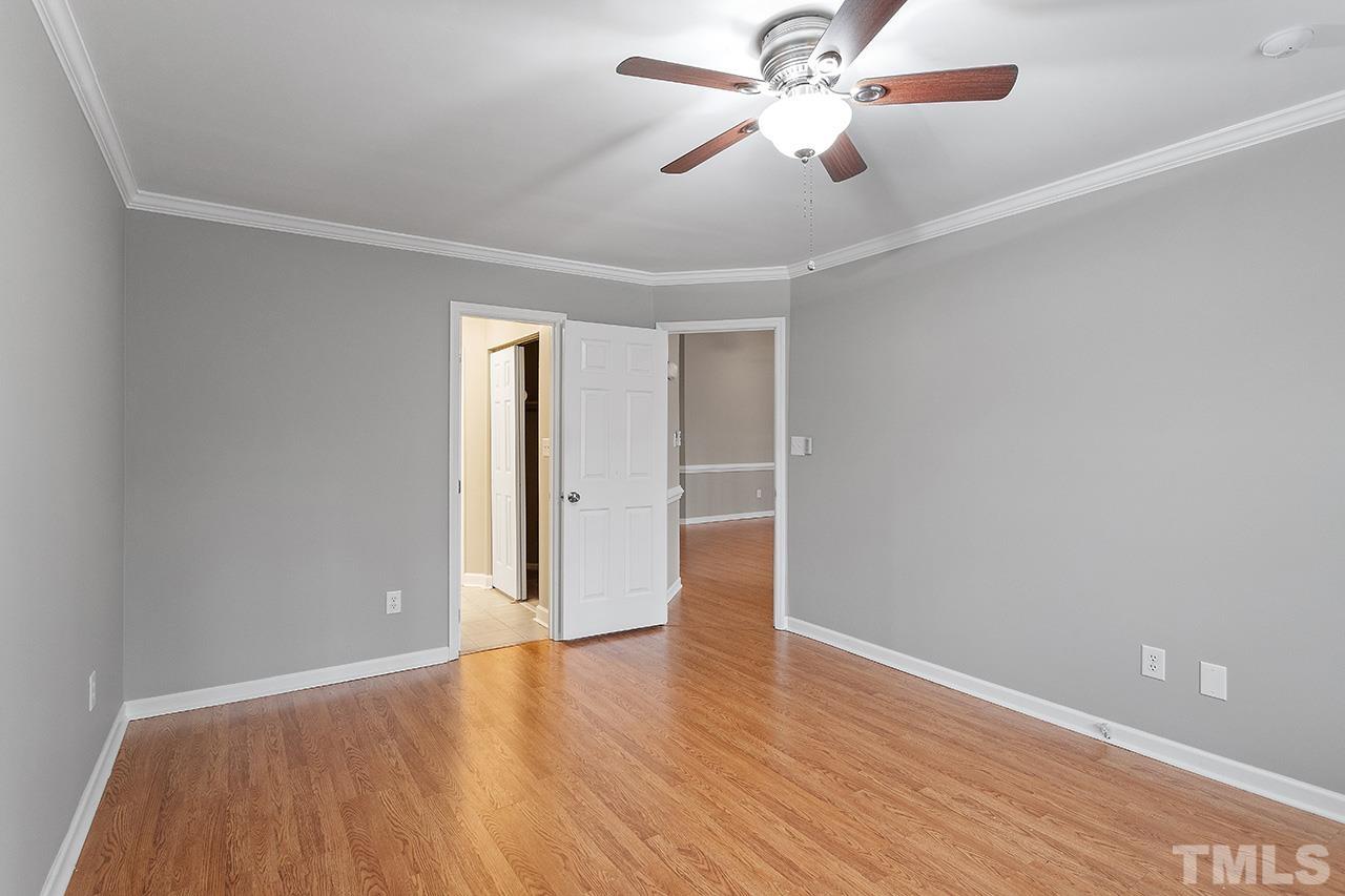 5701 Grasmere Court Raleigh, NC 27609 - Photo 31 of 34 an empty room with wooden floor fan and windows