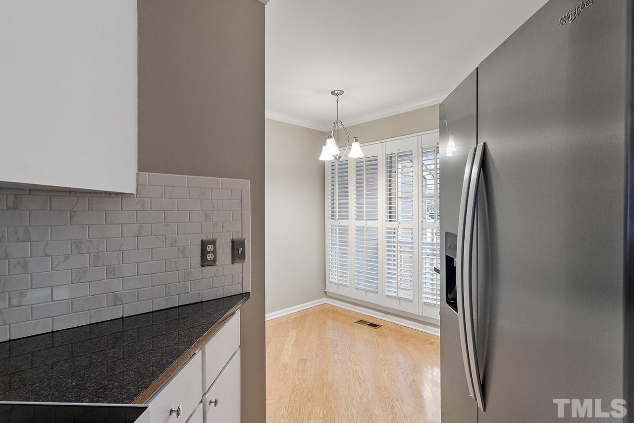 5701 Grasmere Court Raleigh, NC 27609 - Photo 10 of 34 a view of a kitchen with a sink and dishwasher in kitchen with granite countertop cabinets