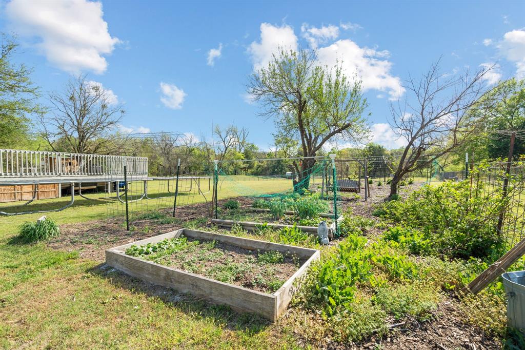 112 Waterfall Court Azle, TX 76020 - Photo 35 of 40 a view of a backyard with wooden fence