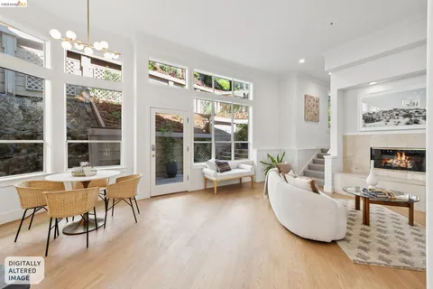 a living room with furniture a fireplace and a large window
