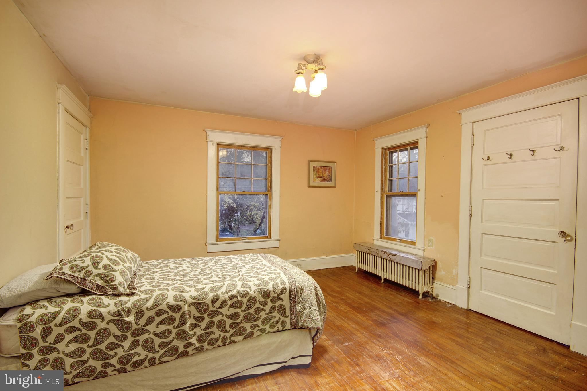 616 Camden Avenue Salisbury, MD 21801 - Photo 11 of 24 a bedroom with a bed and wooden floor