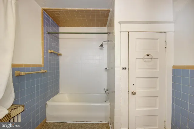 a bathroom with a bathtub and shower