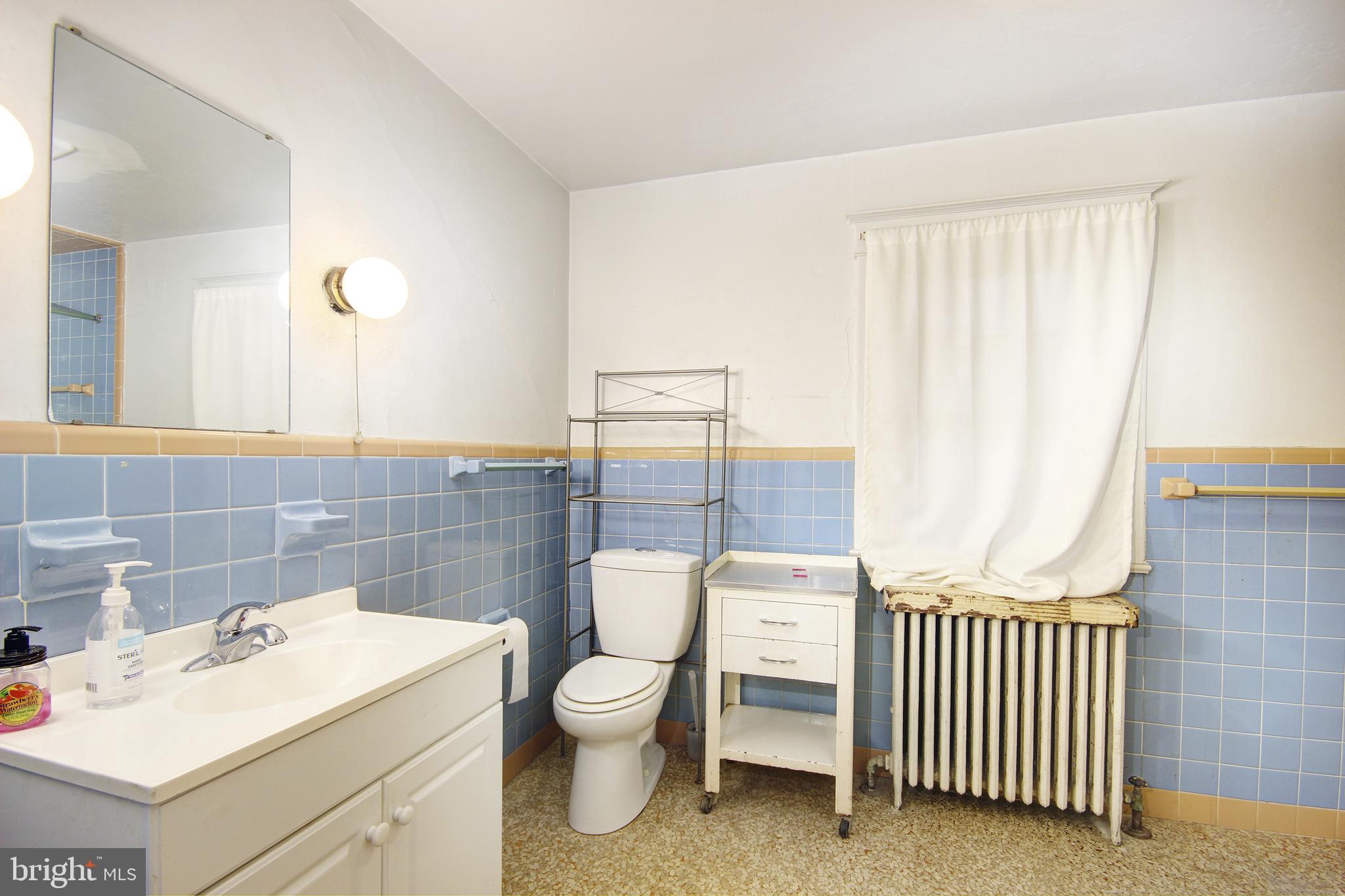 616 Camden Avenue Salisbury, MD 21801 - Photo 14 of 24 a bathroom with a toilet sink and mirror