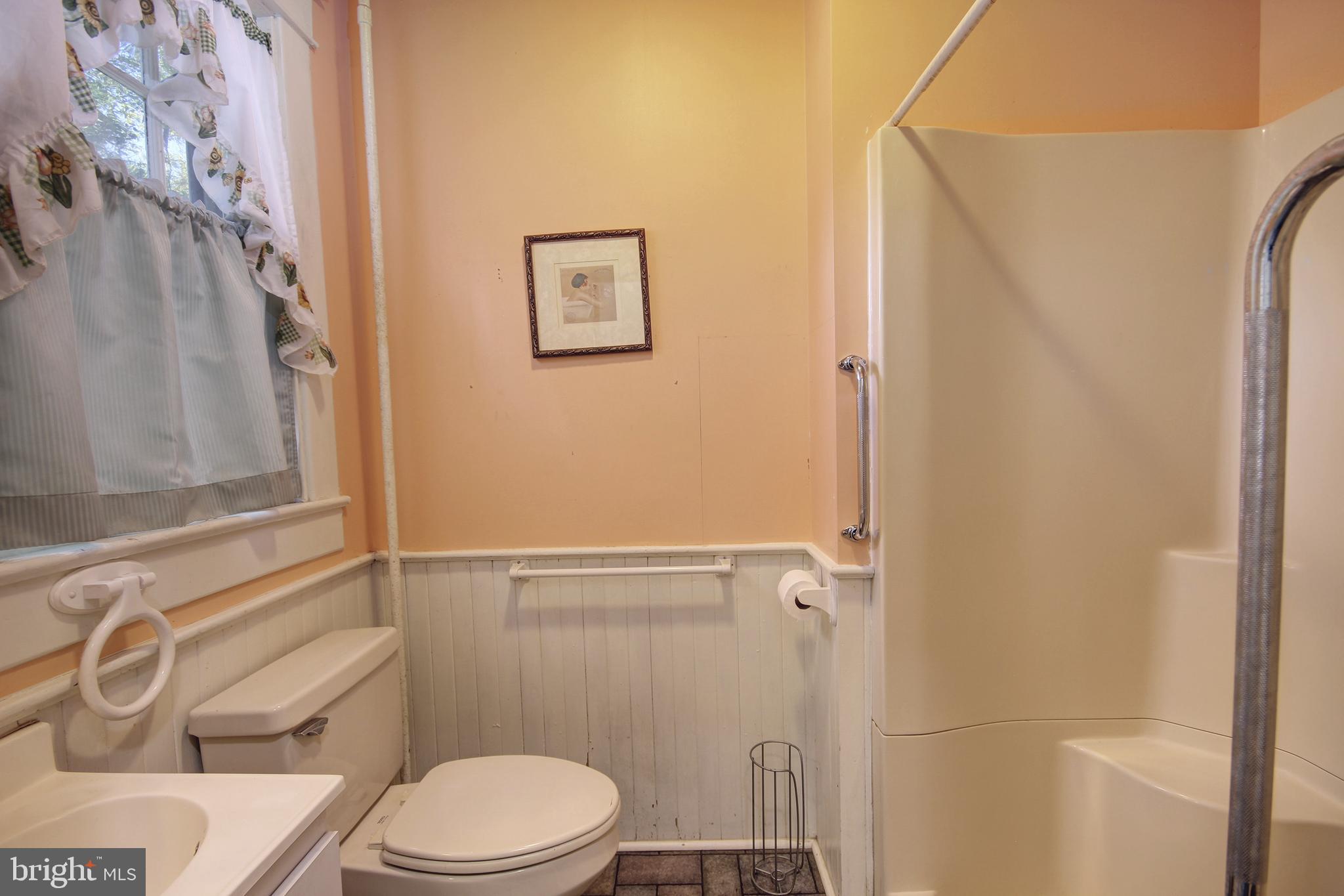 616 Camden Avenue Salisbury, MD 21801 - Photo 17 of 24 a white toilet sitting next to a shower curtain