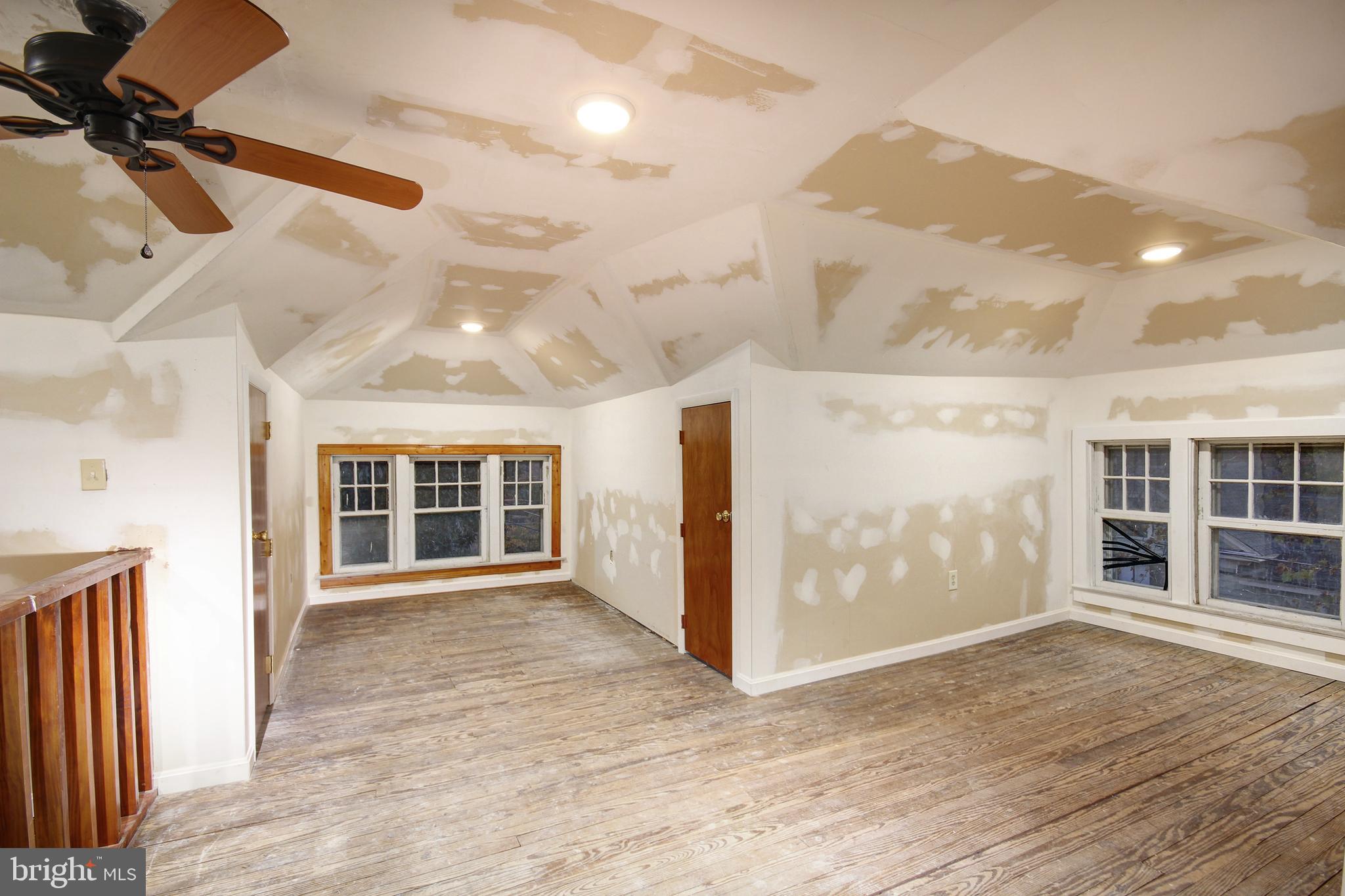 616 Camden Avenue Salisbury, MD 21801 - Photo 18 of 24 an empty room with wooden floor and windows