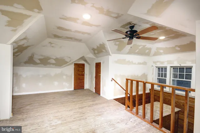 a view of a hallway with a ceiling fan
