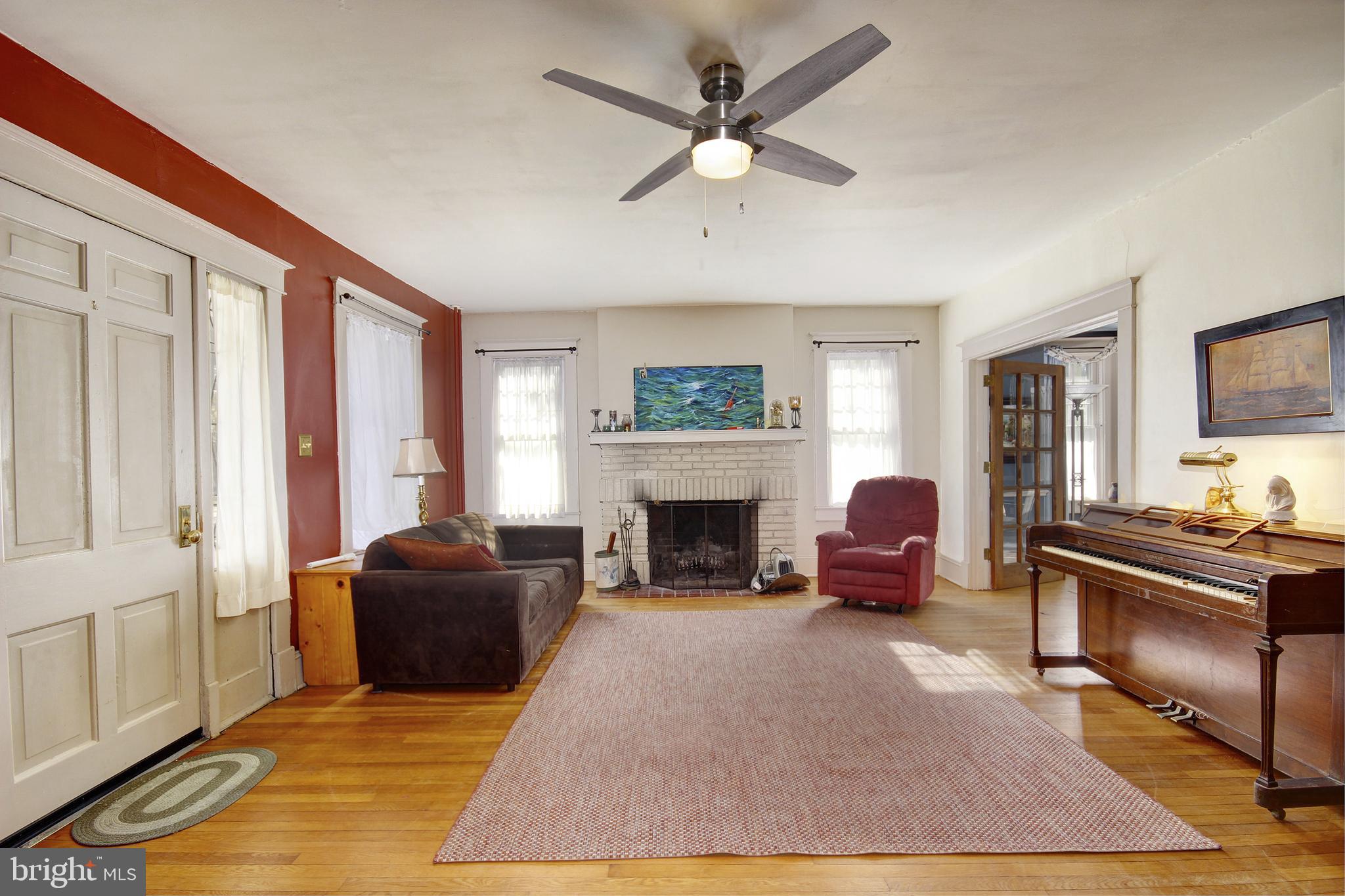 616 Camden Avenue Salisbury, MD 21801 - Photo 6 of 24 a living room with furniture a fireplace and a flat screen tv