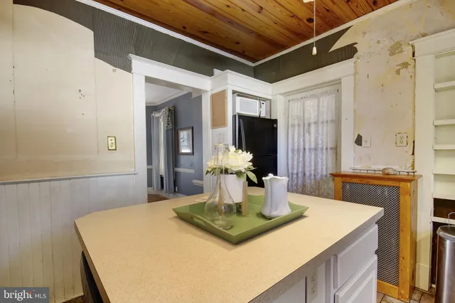 a view of kitchen island with granite countertop sink