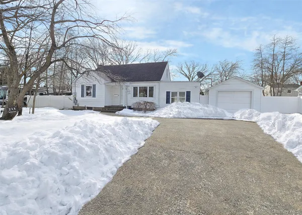 front view of a house with a yard covered in snow