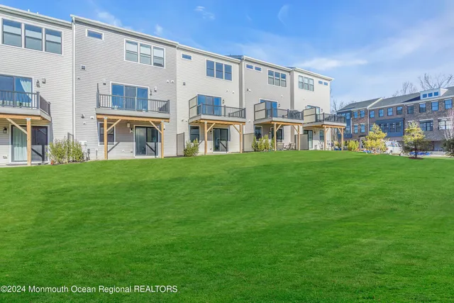 a front view of a building with a garden