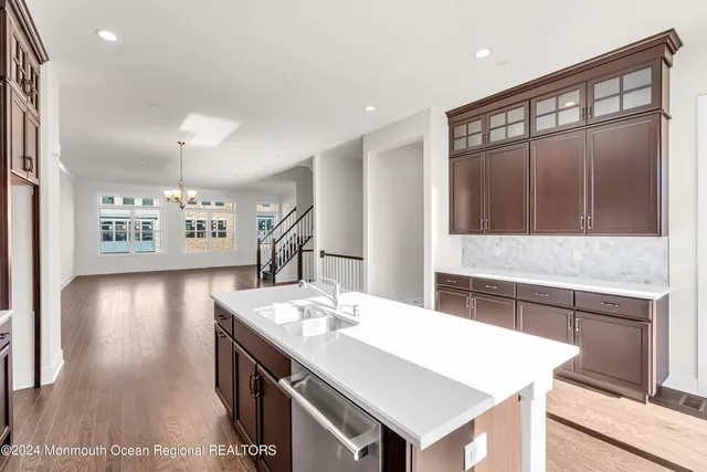 a kitchen with a stove a sink and a refrigerator