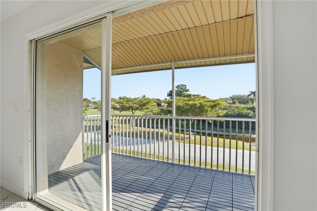 240 Pebble Beach Boulevard, Unit 712 Naples, FL 34113 - Photo 20 of 22 a view of a balcony with wooden floor