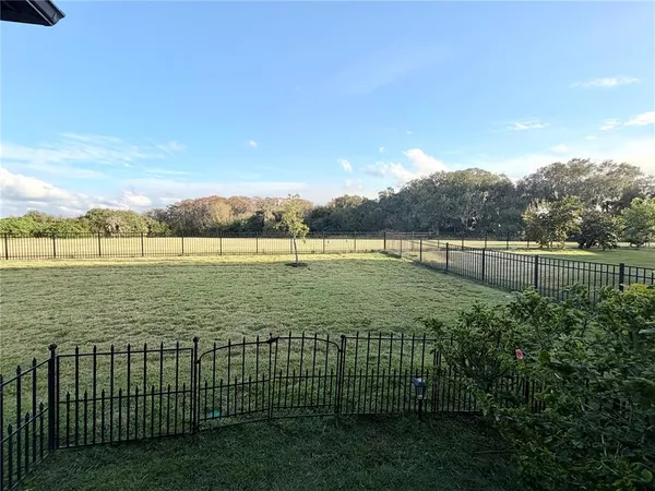 a view of outdoor space with green field and lake view