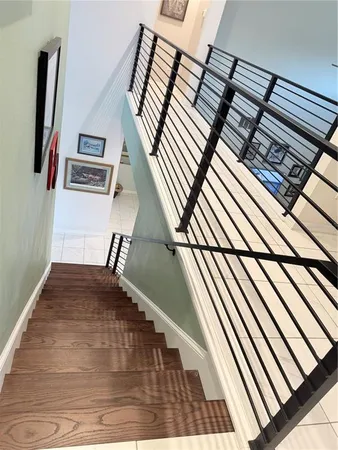 a view of a living room with furniture and wooden floor