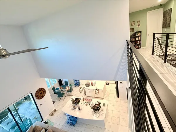 a view of a hallway with wooden floor and stairs