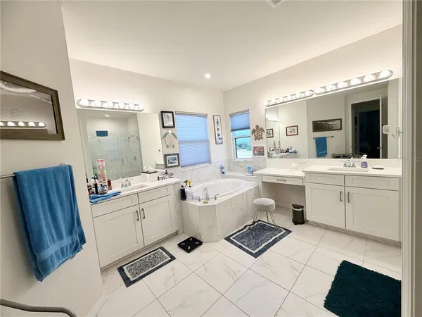 a living room with furniture a flat screen tv and a table