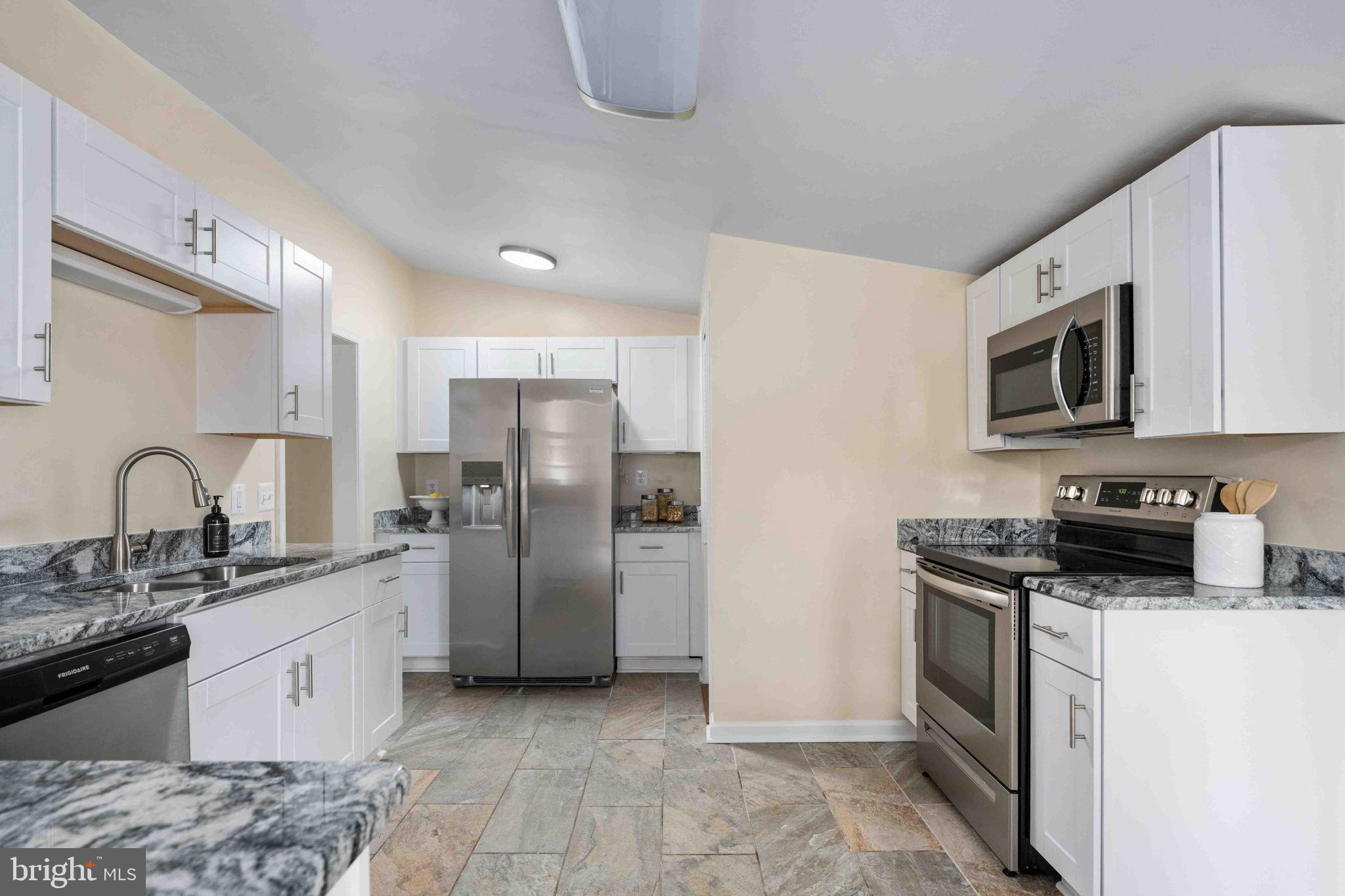 116 Lakeview Parkway Locust Grove, VA 22508 - Photo 22 of 71 a kitchen with stainless steel appliances granite countertop a refrigerator sink and stove