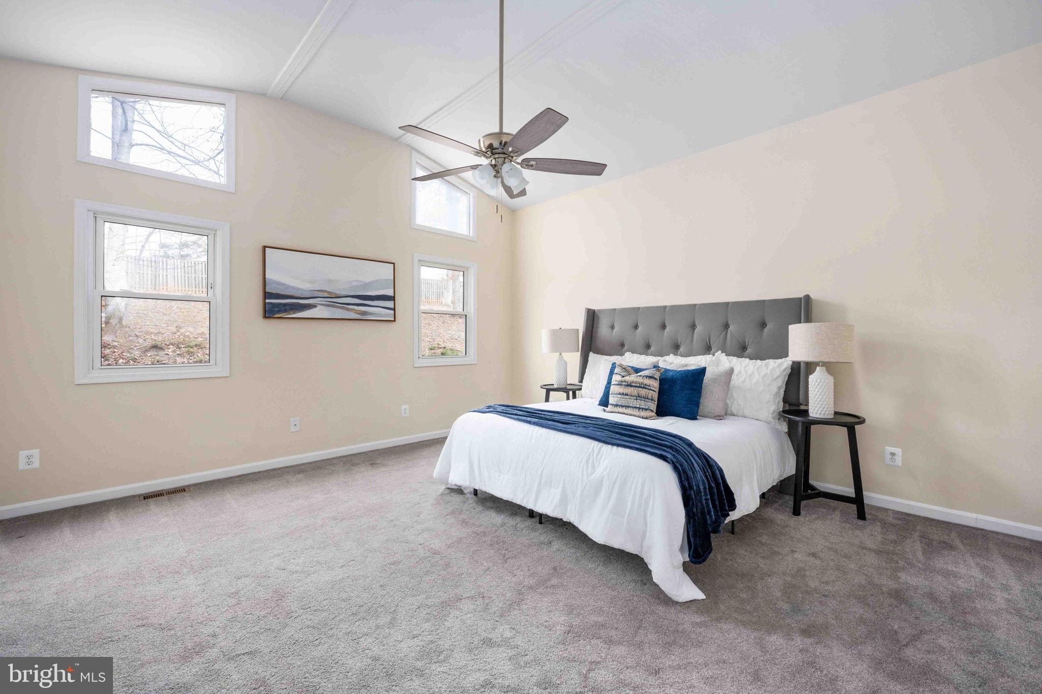 116 Lakeview Parkway Locust Grove, VA 22508 - Photo 37 of 71 a spacious bedroom with a bed and a chandelier