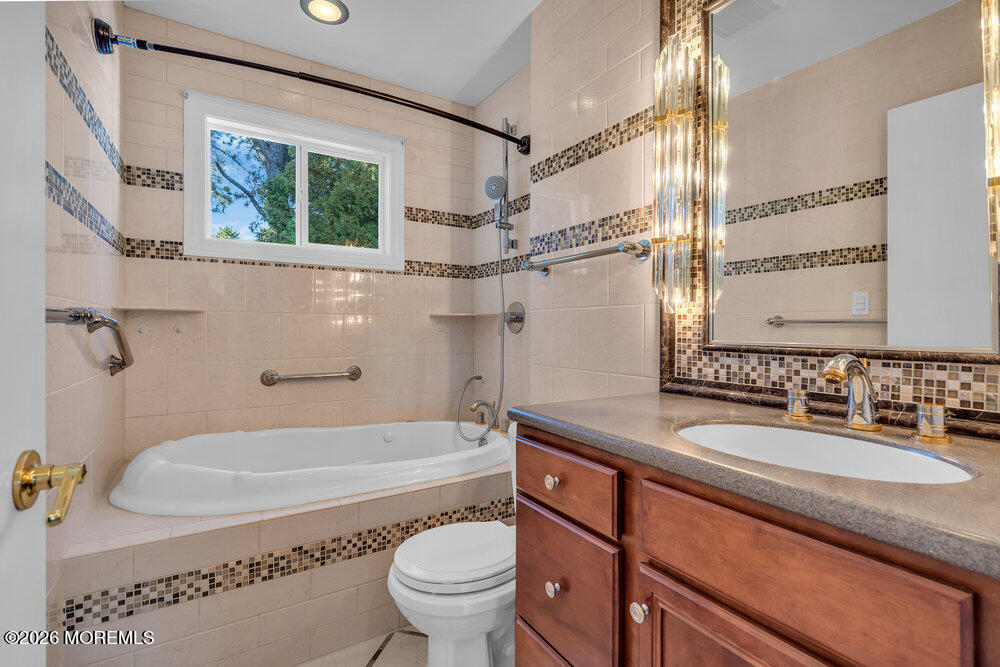 11 Vermont Way Whiting, NJ 08759 - Photo 11 of 14 a bathroom with a sink a toilet a mirror and bathtub