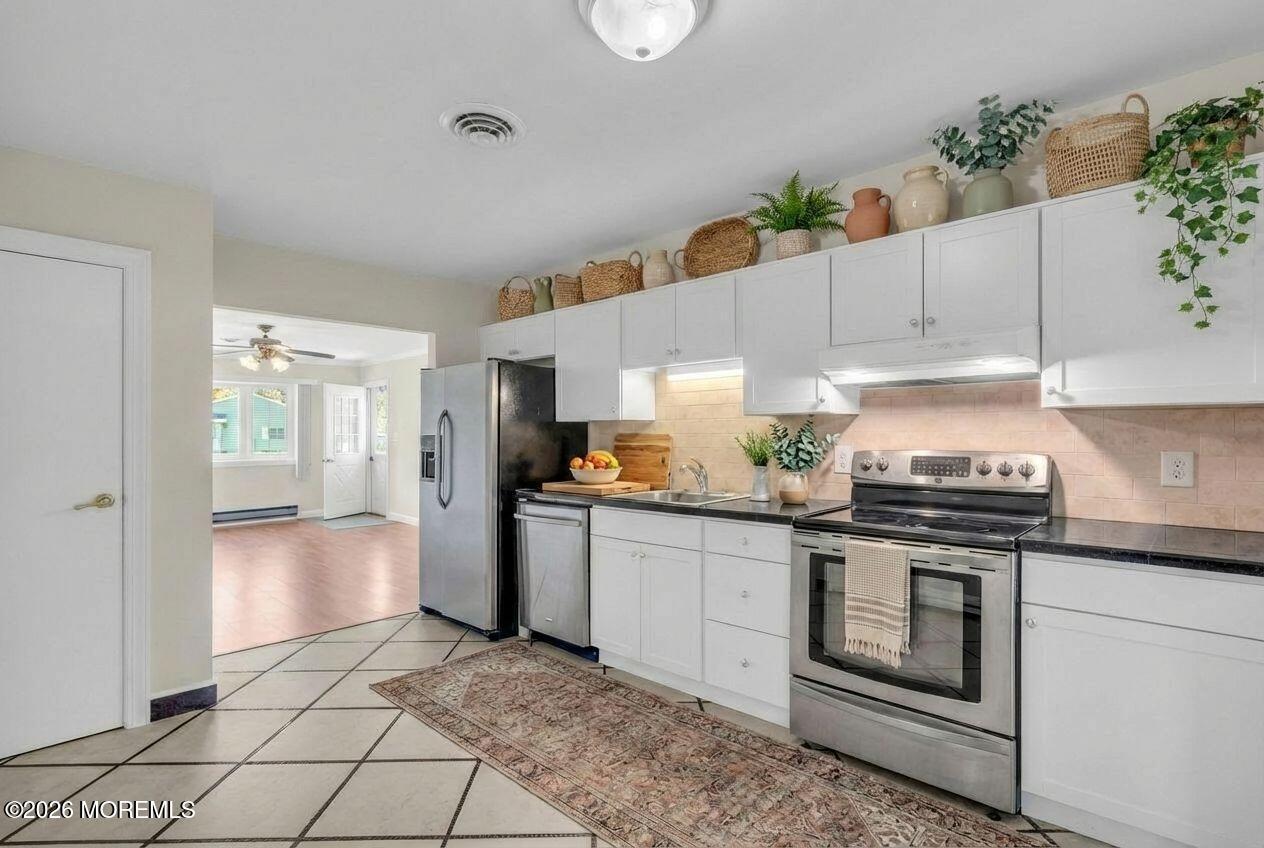 11 Vermont Way Whiting, NJ 08759 - Photo 4 of 14 a kitchen with granite countertop a stove a sink and a refrigerator