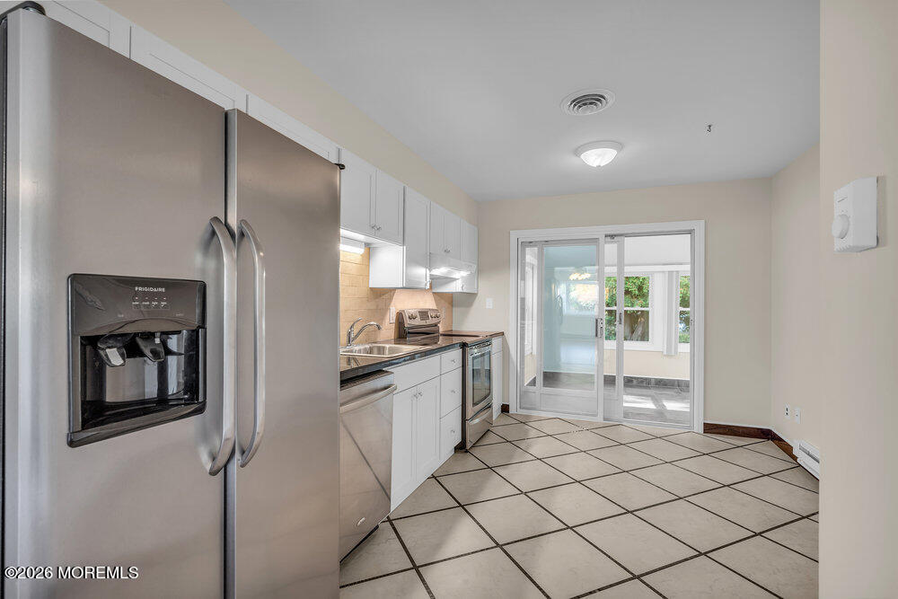 11 Vermont Way Whiting, NJ 08759 - Photo 10 of 14 a kitchen with stainless steel appliances kitchen island granite countertop a refrigerator and a sink