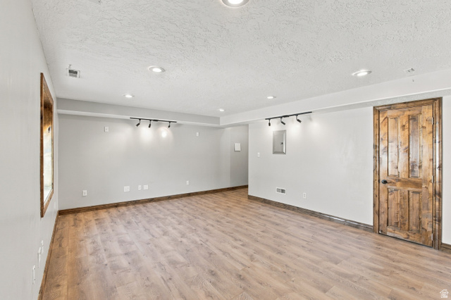 926 Ibis Way Draper, UT 84020 - Photo 24 of 41 Family room in basement with recessed ceiling, wired for suround sound, ethernet wired, beautiful alder doors, windows and baseboards. The closet has the same lovely flooring.