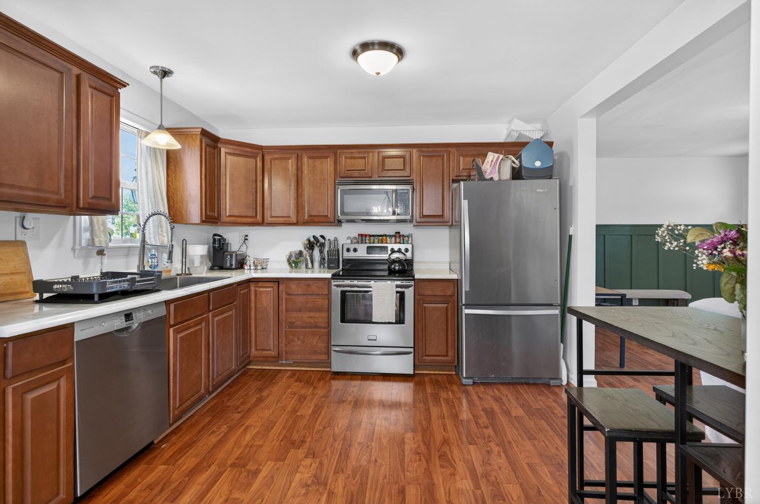 1305 Harding Street Lynchburg, VA 24502 - Photo 5 of 33 a kitchen with wooden floors appliances and cabinets