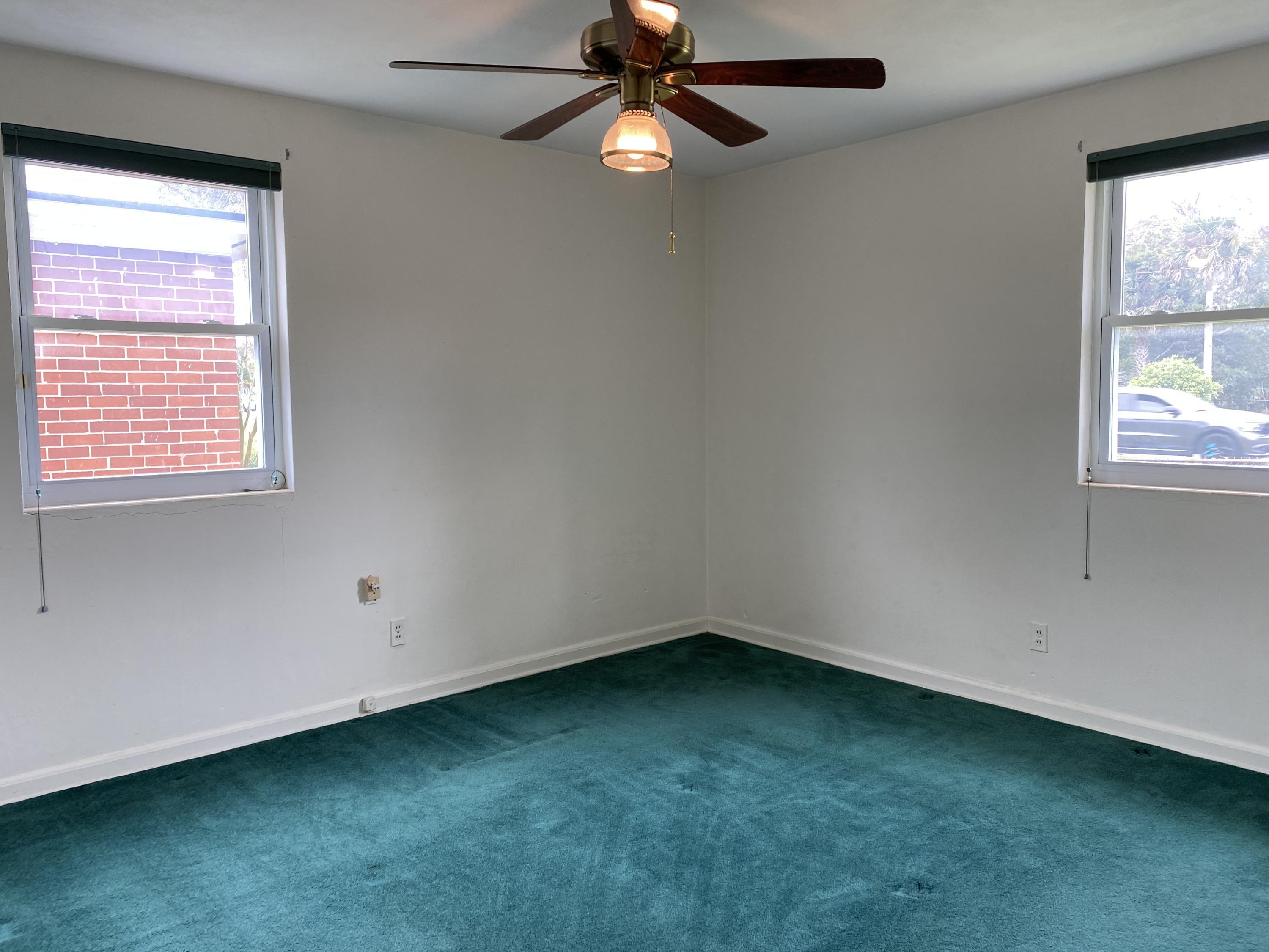 1907 Penman Road Jacksonville Beach, FL 32250 - Photo 20 of 25 an empty room with a window and a fan