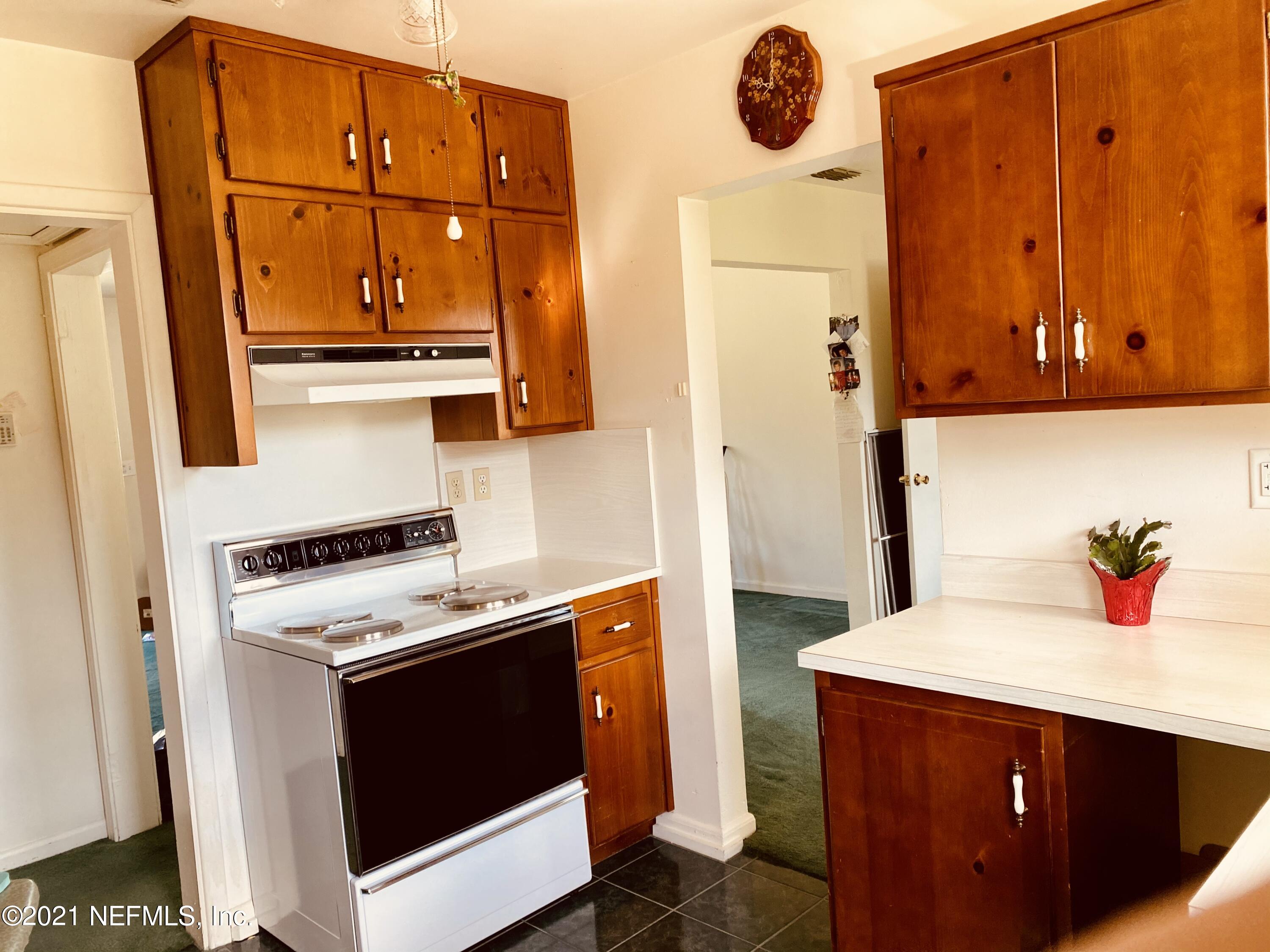 1907 Penman Road Jacksonville Beach, FL 32250 - Photo 10 of 25 a kitchen with a refrigerator and a stove