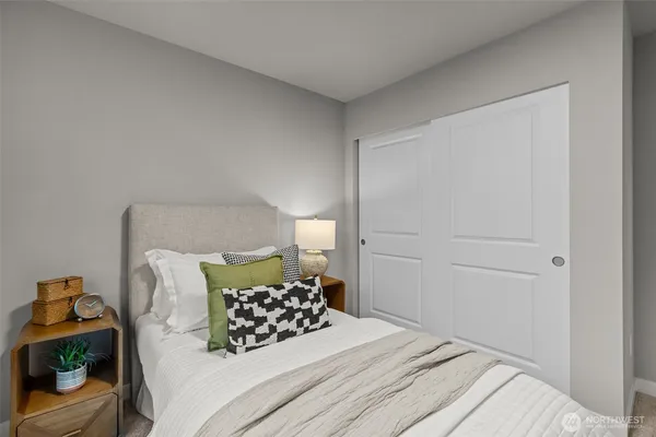 a bedroom with a bed and a couch