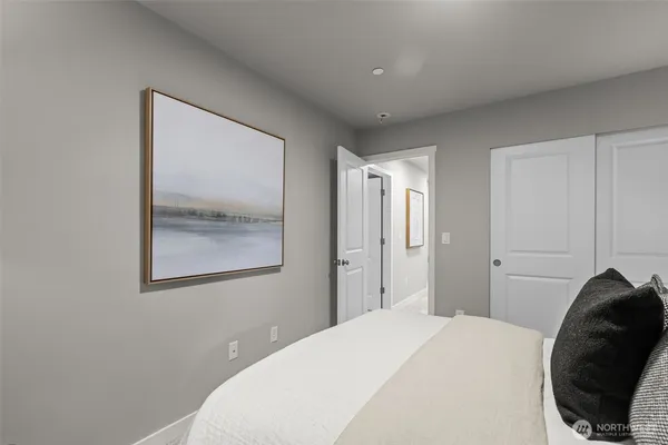 a bedroom with a bed and a painting on the wall