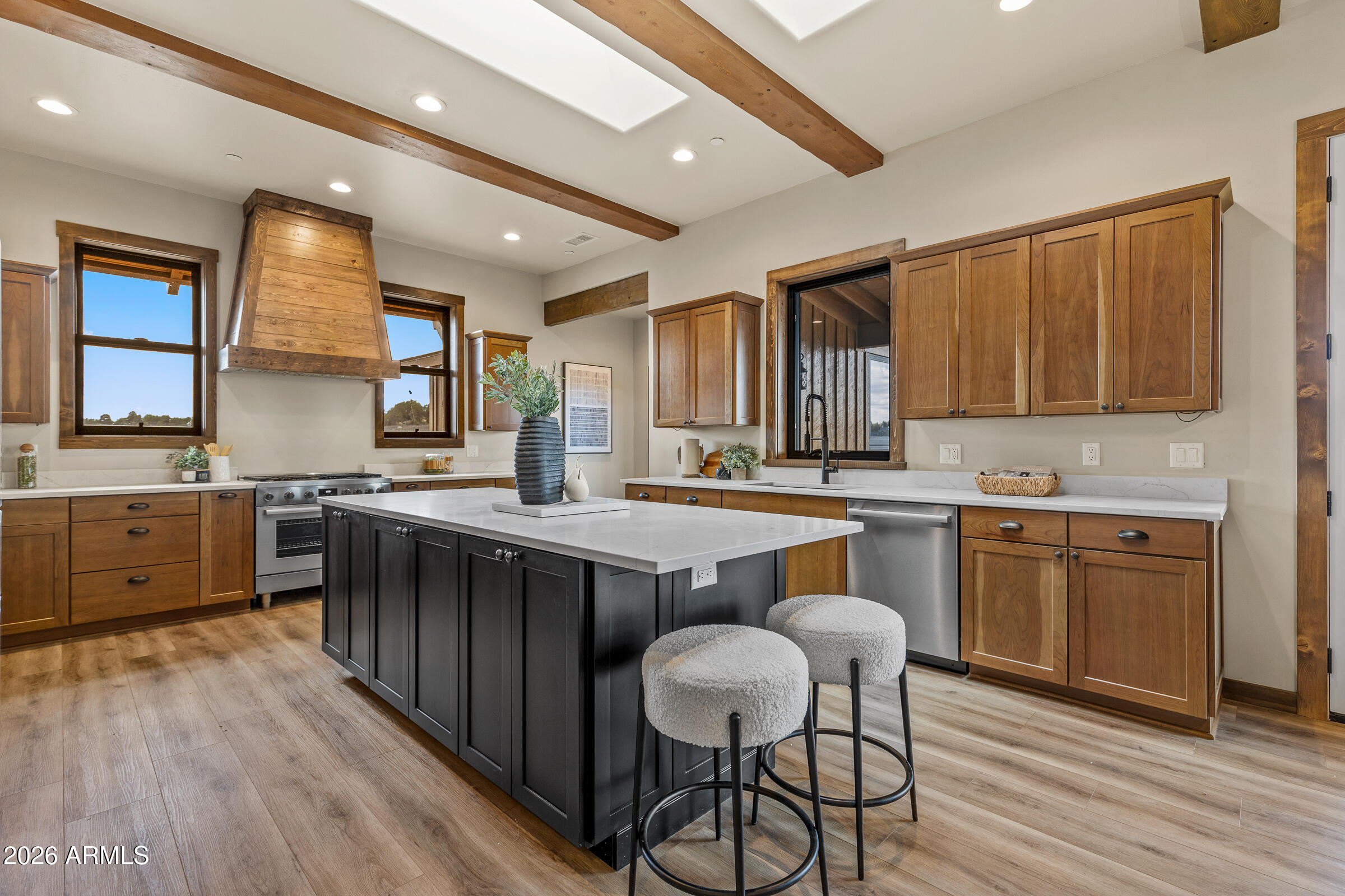 6570 Meadows Lane Flagstaff, AZ 86004 - Photo 15 of 66 a kitchen with stainless steel appliances kitchen island granite countertop wooden floors and wooden cabinets