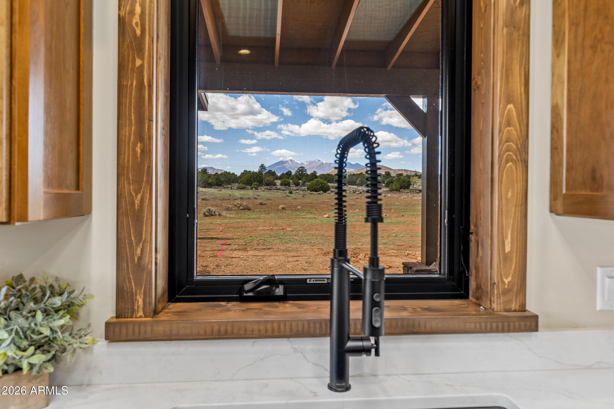 6570 Meadows Lane Flagstaff, AZ 86004 - Photo 19 of 66 a front view of a house with a porch and glass door