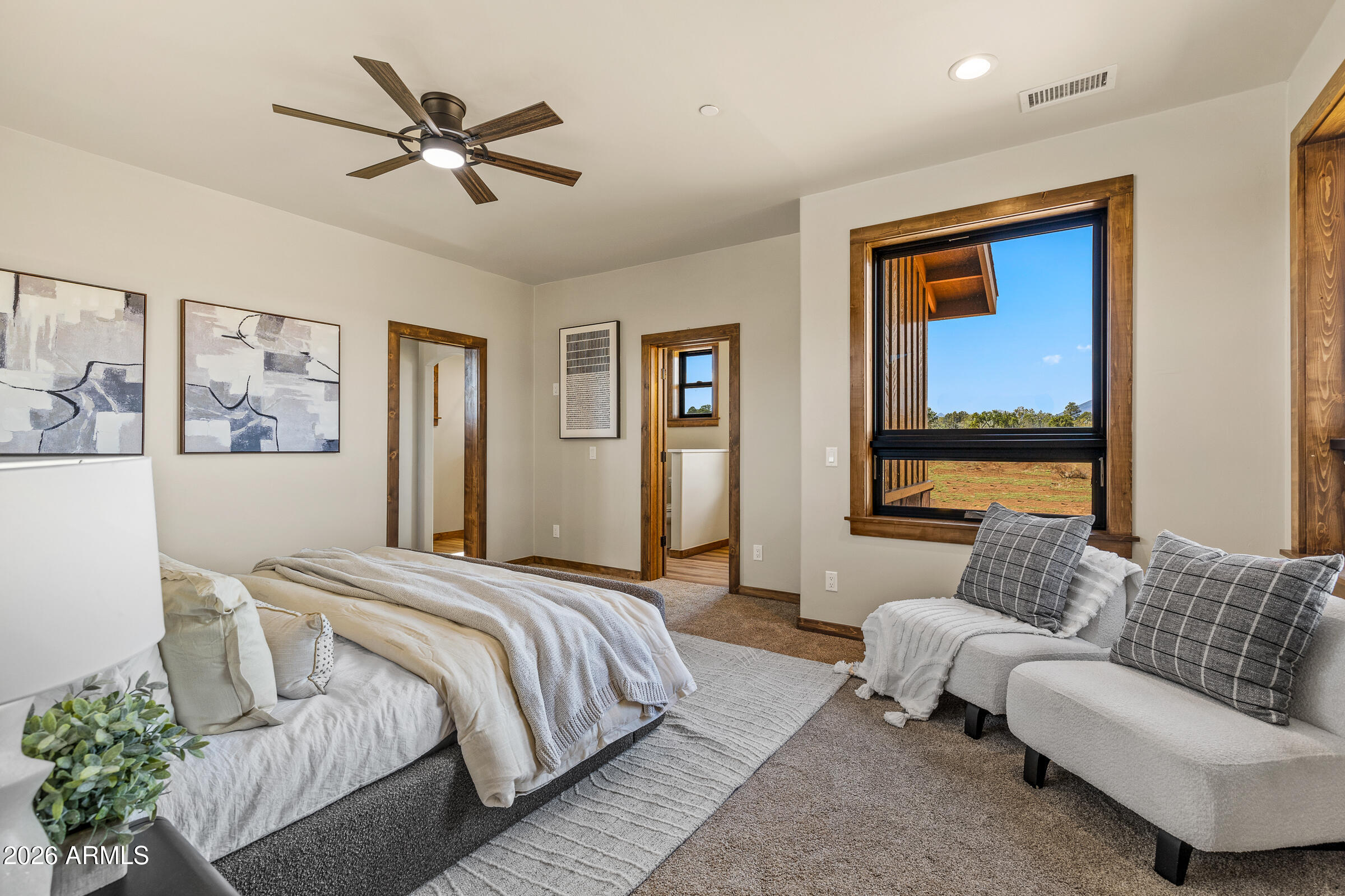 6570 Meadows Lane Flagstaff, AZ 86004 - Photo 23 of 66 a spacious bedroom with a bed couch and window