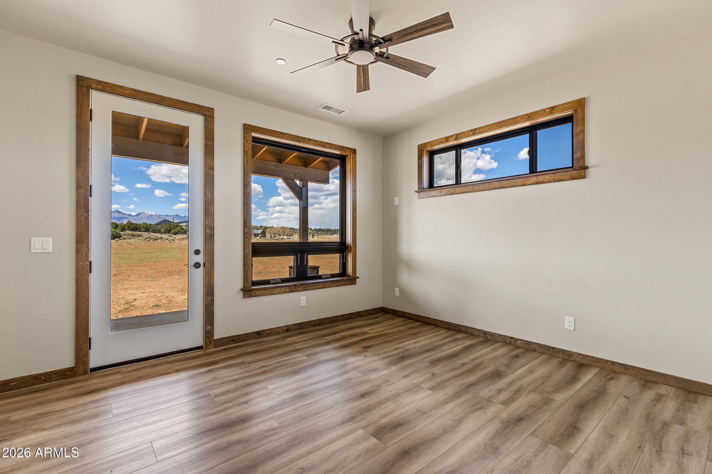 6570 Meadows Lane Flagstaff, AZ 86004 - Photo 28 of 66 wooden floor in an empty room with a window