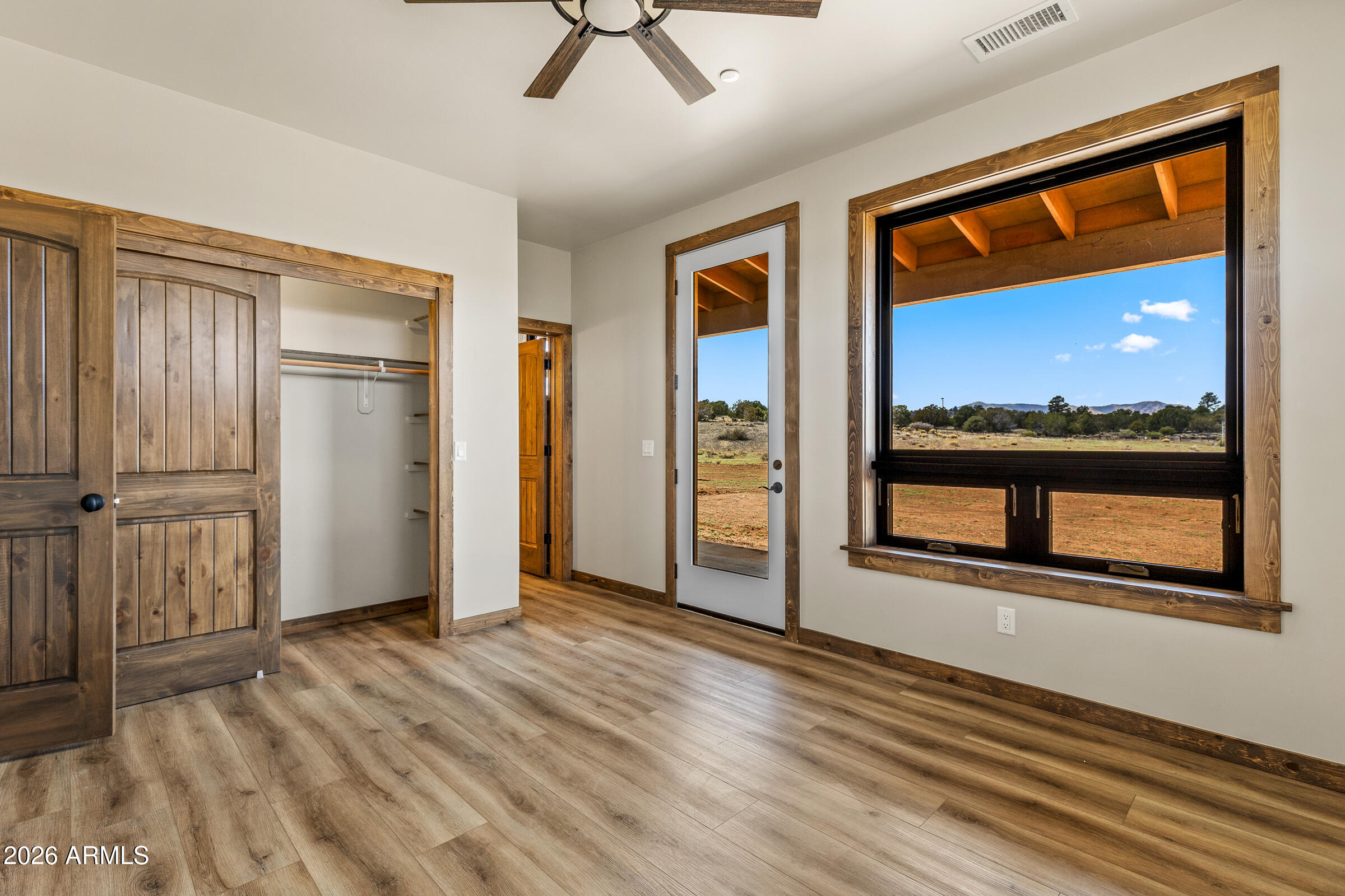 6570 Meadows Lane Flagstaff, AZ 86004 - Photo 29 of 66 an empty room with wooden floor and a window