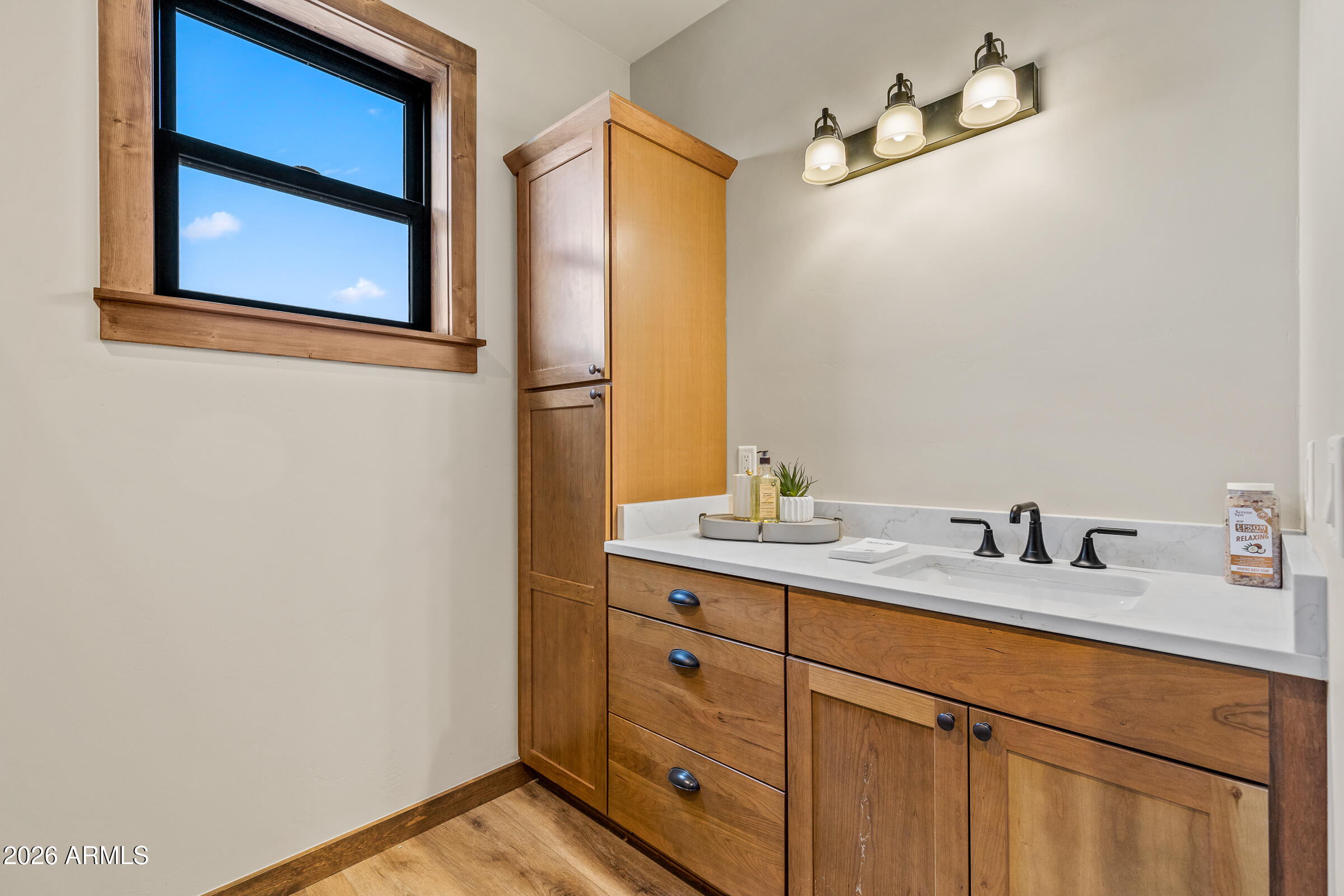 6570 Meadows Lane Flagstaff, AZ 86004 - Photo 33 of 66 a bathroom with a granite countertop sink and a mirror