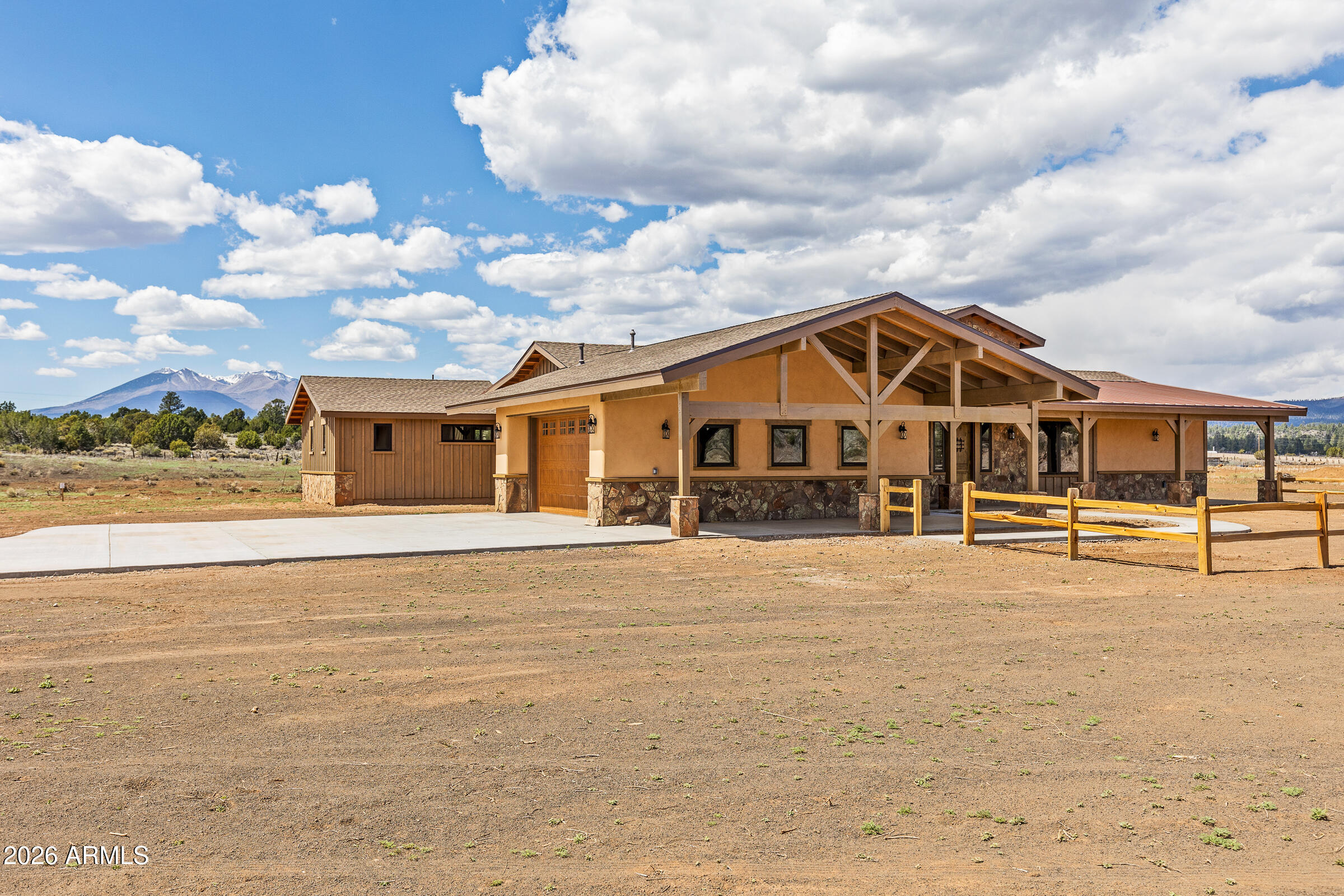 6570 Meadows Lane Flagstaff, AZ 86004 - Photo 4 of 66 a view of a white house with a yard