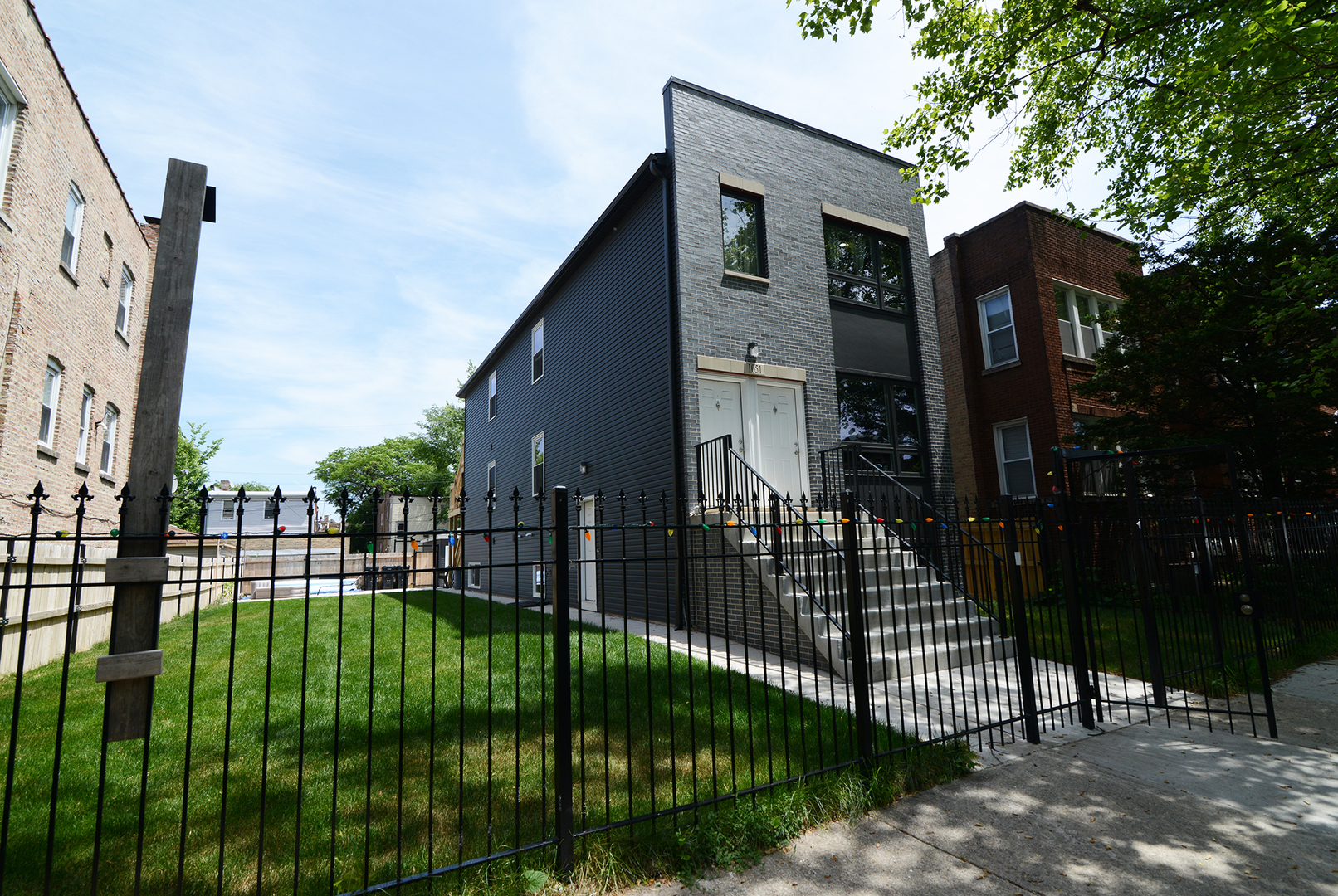 1051 North Springfield Avenue Chicago, IL 60651 - Photo 18 of 50 a view of a brick house with a large trees