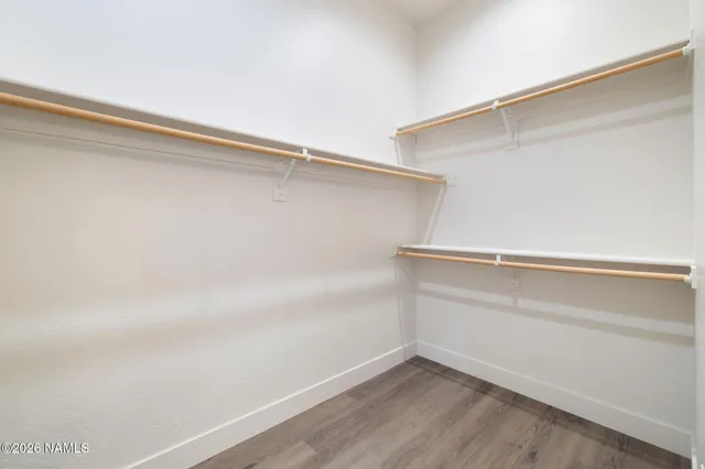 a bedroom with a bed and a ceiling fan